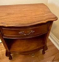 Front view of Broyhill wooden nightstand showing drawer, shelf, legs