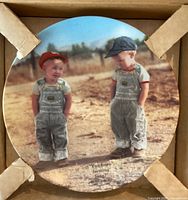 Front of porcelain plate showing farm scene with two boys and caption