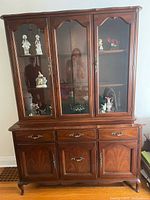 Full view of hutch showing upper glass display and lower drawers/doors