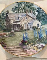 Front of porcelain plate showing homestead garden artwork