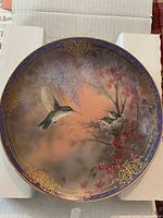 Front view of plate showing hummingbird artwork and gold border