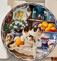 Front of plate showing artwork of cats, fruit and preserves