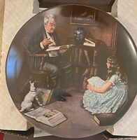 Front view of plate in box showing illustration and overall condition