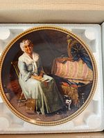 Front of plate in foam insert showing artwork and gold rim