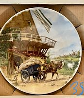 Front of porcelain plate with windmill and horse cart scene