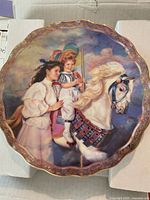 Front view of the Sandra Kuck collector plate showing artwork and gold rim