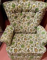 Front view of floral swivel rocker armchair