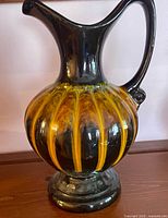 Full view of jug front showing glaze pattern, shape, handle