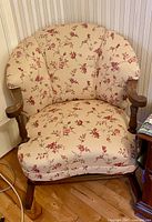 Front view of rocking chair showing upholstery, wood arms, rockers, and added height blocks