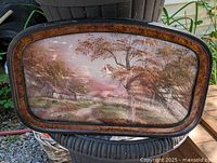 Full view of framed painting showing landscape and convex glass