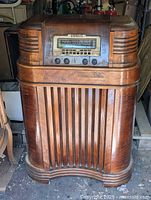 Front view of console radio showing full wooden cabinet