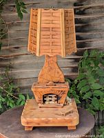 Full view of carved cedar fireplace lamp with shade