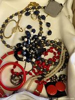 Assorted jewellery pieces on white cloth