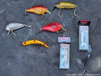 Group shot of eight lures including two boxed Rapala Originals and six loose crankbaits