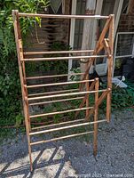 Front view of vintage wooden folding drying rack fully extended