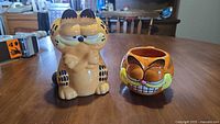 Front view of Garfield coin bank and mug