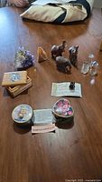 Full lot view with elephants, crystals, boxes and tins