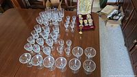 Wide view of table showing all crystal stemware, gold-tone set in box