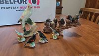 All six ceramic bird figurines on table