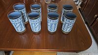 Eight blue and white Greek motif highball glasses on table