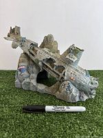 Front view of resin submarine ornament with Sharpie for scale