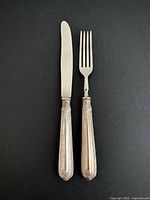 Knife and fork full view on black background