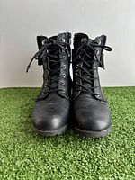 Front view of both black Ardene ankle boots laced up