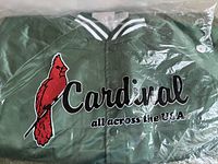 Jacket in original poly bag showing Cardinal logo and green satin material