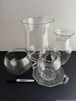Group shot showing all five clear glass pieces with size reference