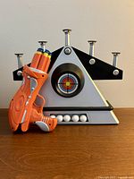 target base and blaster with darts and balls visible