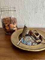 Jar of pennies with dish of trinkets