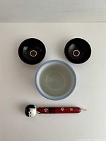 Top view showing cup interior, two dishes, pen