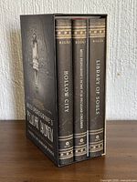 Three hardcovers in slipcase, spines visible