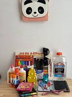 Full lot overview with panda purse on hook and items on table