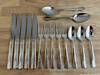 Full set laid out: knives, forks, teaspoons, large spoons