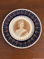 Front view showing portrait, cobalt border and gold decoration