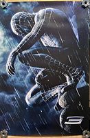 Full view of Spider-Man 3 poster showing black-suited Spider-Man crouched in rain, silver 3 logo bottom right