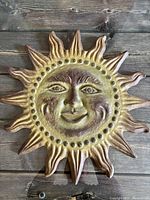 Front view showing sun face design, color, and detail