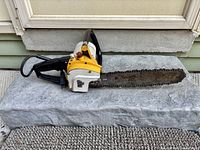 Left side view of electric chainsaw showing full bar and body