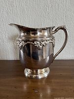 Left side profile showing grapevine band, handle, pedestal base