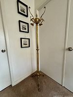 Full view of brass coat and hat rack stand