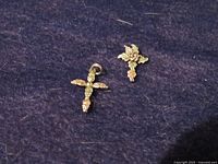 Front view of both cross pendants showing tri-color leaf detailing