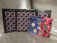 Overview of three stamp sheets and American Spirit coin display