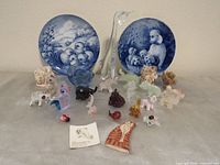 Full lot showing plates, crystal giraffe, trinket boxes, glass and ceramic figurines