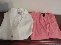 Both jackets folded showing labels