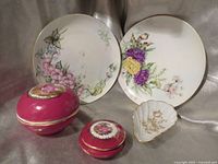 Group shot of two plates, two trinket boxes, one shell dish