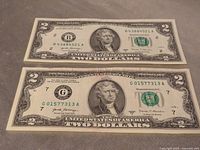 Front of two $2 Series 2017A notes showing serial numbers