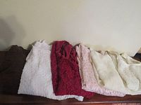Six folded lace tops in assorted colors