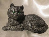 Front three-quarter view showing cat figure, green eyes and overall form