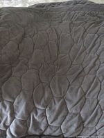 Close view of gray quilted fabric texture